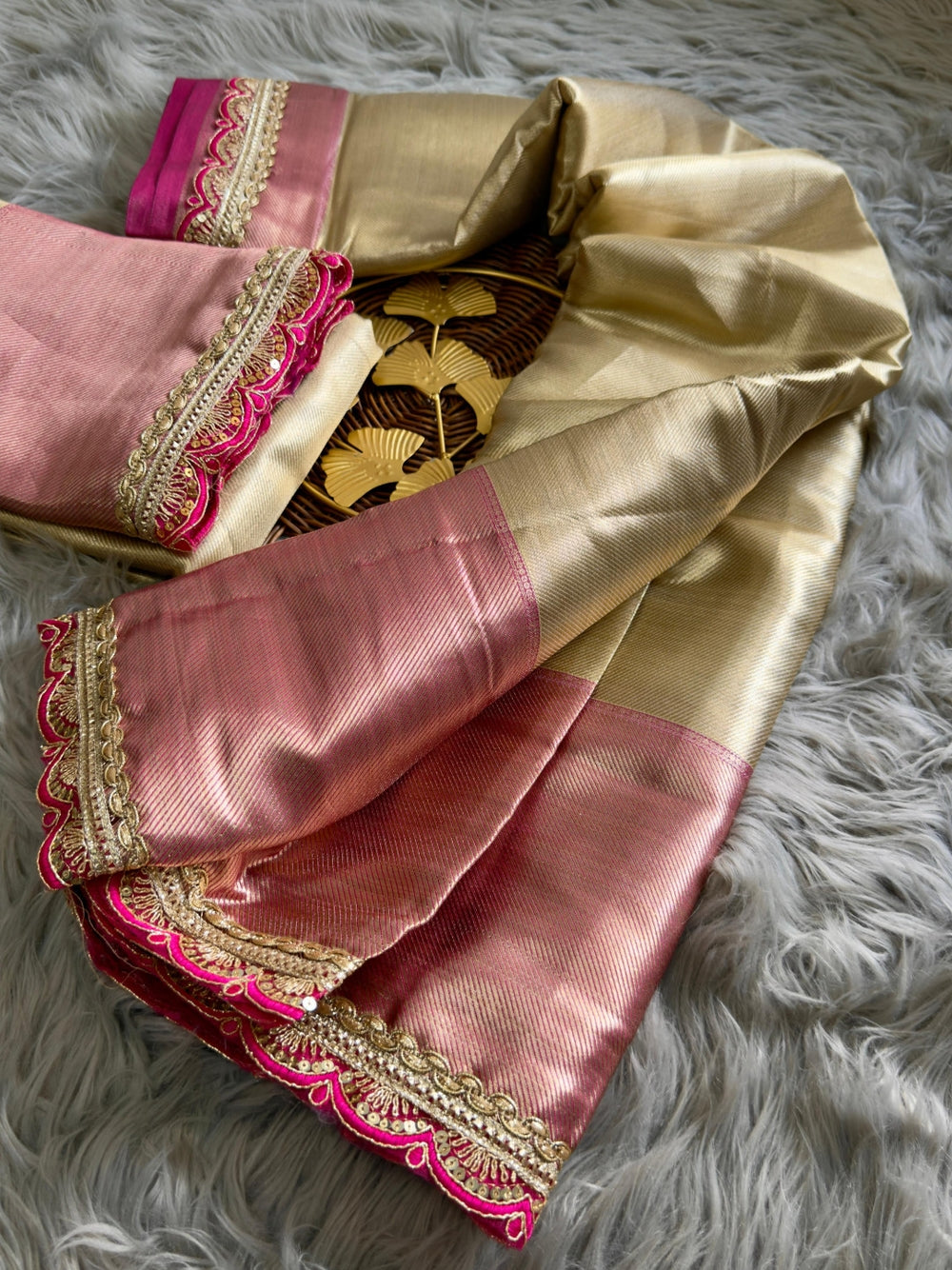 Gold soft tissue silk saree with chex design rich pallu and brocade blouse.
