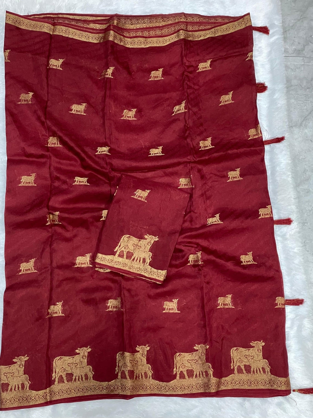 Maroon viscose dola silk saree with slef zari weaving work.